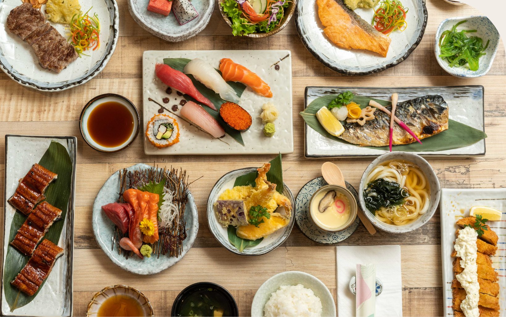 A selection of Fukuya's Japanese dishes — sashimi, sushi, grilled fish, tempura, and udon.